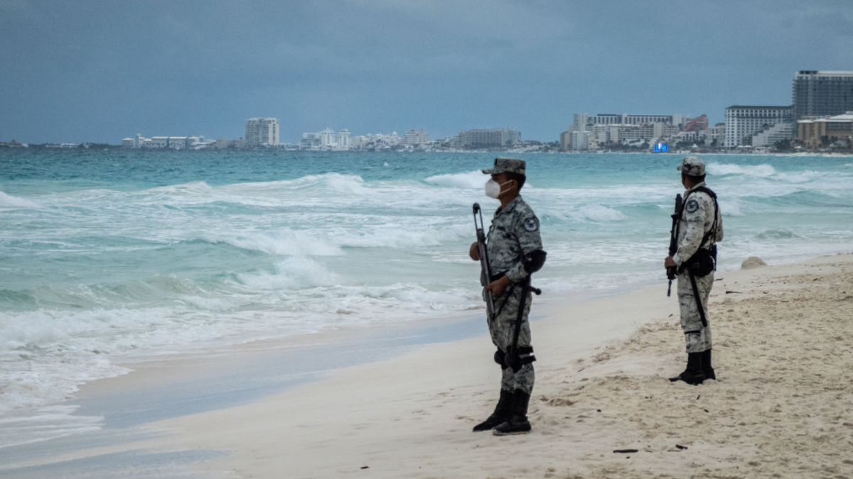 Members of the National Guard patrol a beach in the Hotel Zone of Cancun, Quintana Roo state, Mexico, on Thursday, Dec. 2, 2021. Mexico deployed a battalion of almost 1,500 National Guard troops to Cancun and surrounding beaches after two separate deadly shootouts sparked concerns over the security of the Riviera Maya region, the countrys top tourist destination. (Cesar Rodriguez/Bloomberg via Getty Images)