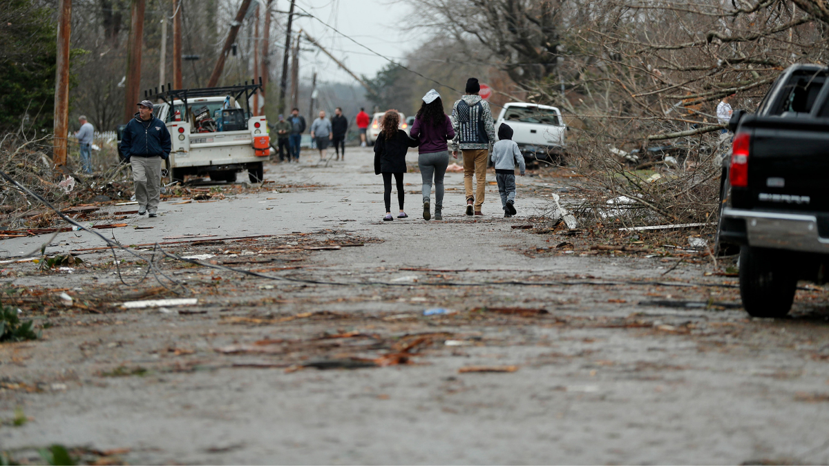 Bowling Green, Kentucky, residents look at the damage following a tornado that struck the area