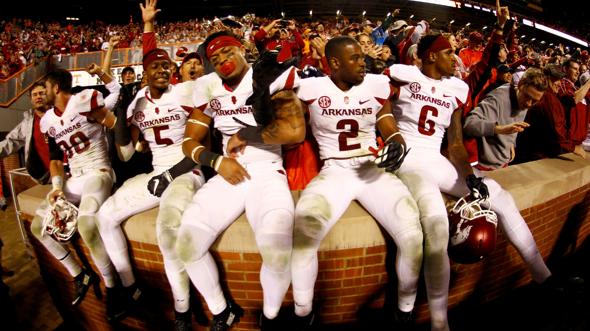 A few members of the Arkansas Razorbacks celebrate with the fans after the victory. 