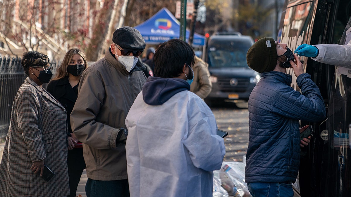 A person has a COVID-19 test administered at a walk up testing site on December 15, 2021 in New York City. (Photo by David Dee Delgado/Getty Images)