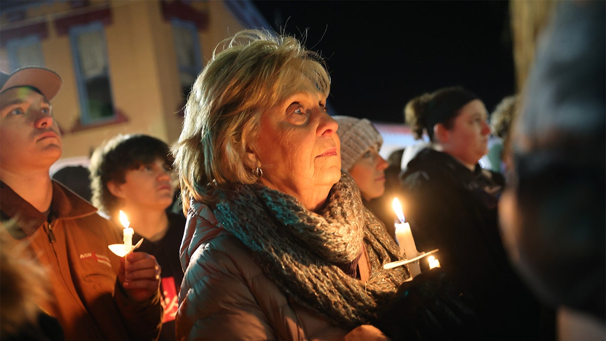 People attend a vigil downtown on Dec. 3, 2021, in Oxford, Michigan, to honor those killed and wounded during the recent shooting at Oxford High School.