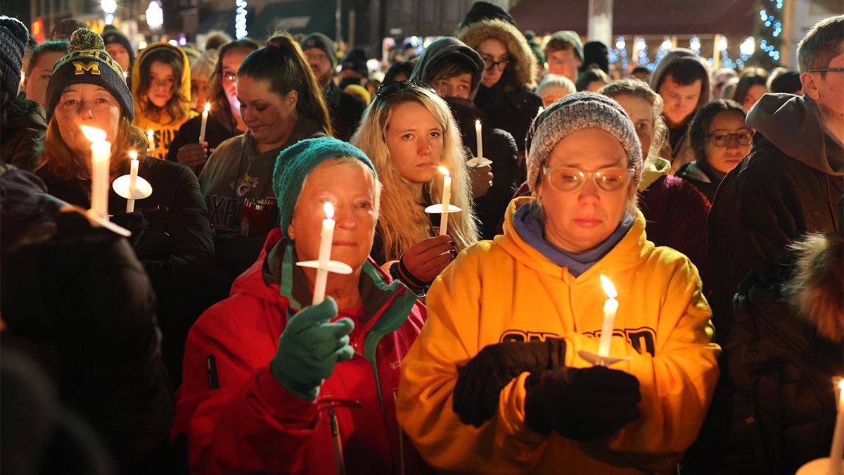People attend a vigil downtown to honor those killed and wounded during the recent shooting at Oxford High School on December 03, 2021 in Oxford, Michigan. (Photo by Scott Olson/Getty Images)
