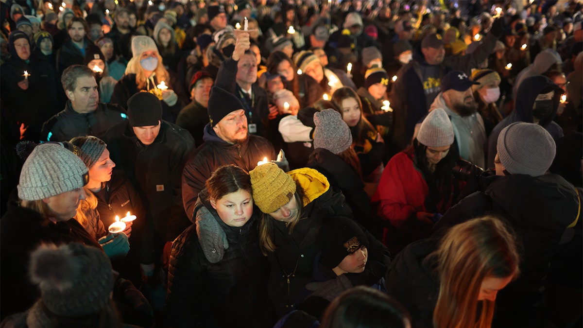 OXFORD, MICHIGAN - DECEMBER 03: People attend a vigil downtown to honor those killed and wounded during the recent shooting at Oxford High School on December 03, 2021 in Oxford, Michigan. Four students were killed and seven others injured on November 30, when student Ethan Crumbley allegedly opened fire with a pistol at the school. Crumbley has been charged in the shooting. Today his parents were also charged.   (Photo by Scott Olson/Getty Images)