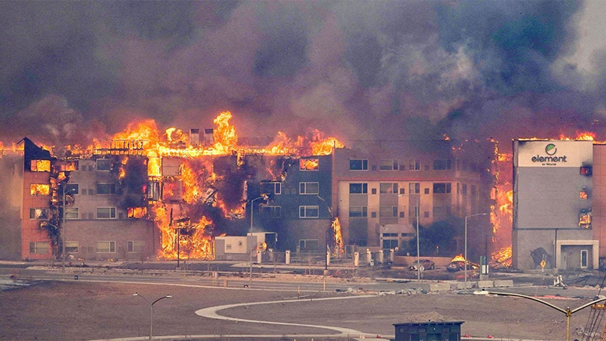 Structures burn, including an Element Hotel, as a wind-driven wildfire forced evacuation of the Superior suburb of Boulder, Colorado, U.S. December 30, 2021.  Trevor Hughes/USA Today Network via Reuters