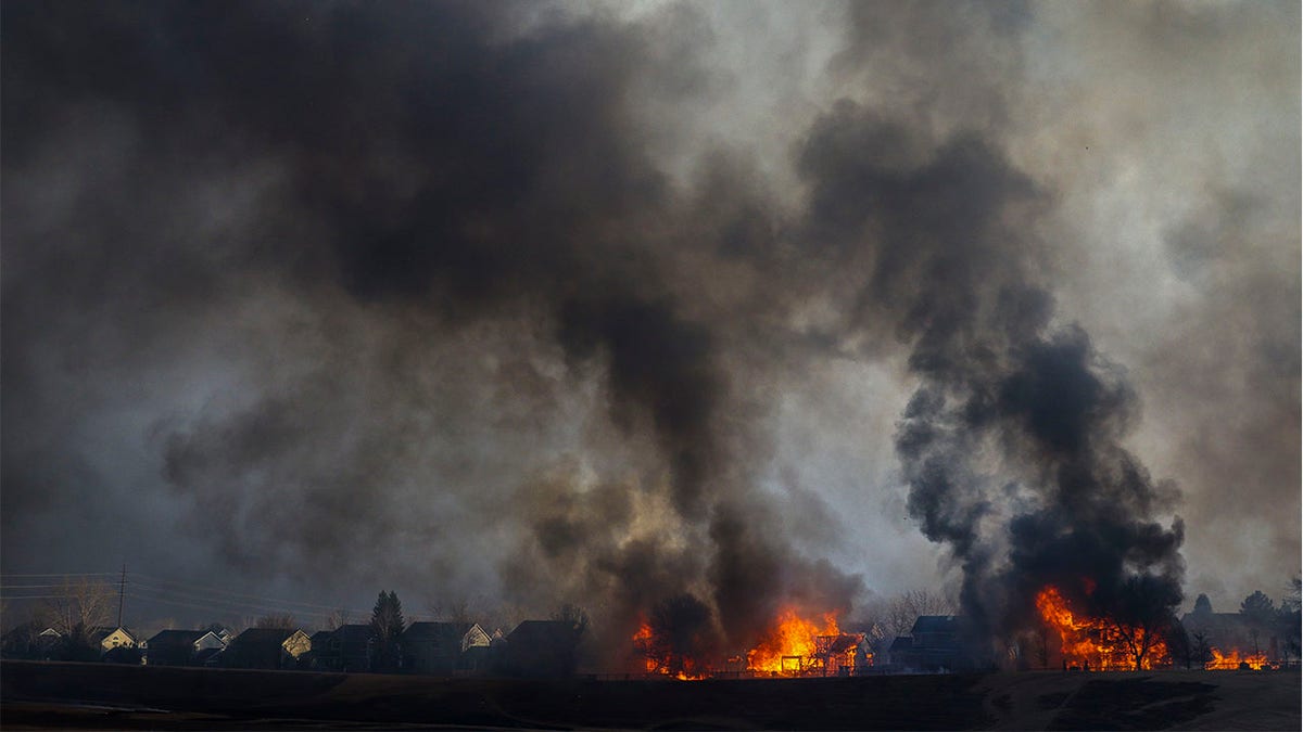 Two homes burn after being consumed by wildfire in the Centennial Heights neighborhood on Dec. 30, 2021, in Louisville, Colorado.