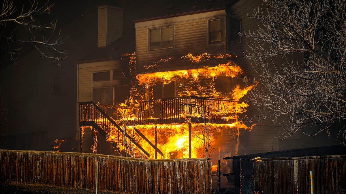 A home burns after a fast-moving wildfire swept through the area in the Centennial Heights neighborhood on Dec. 30, 2021, of Louisville, Colorado.