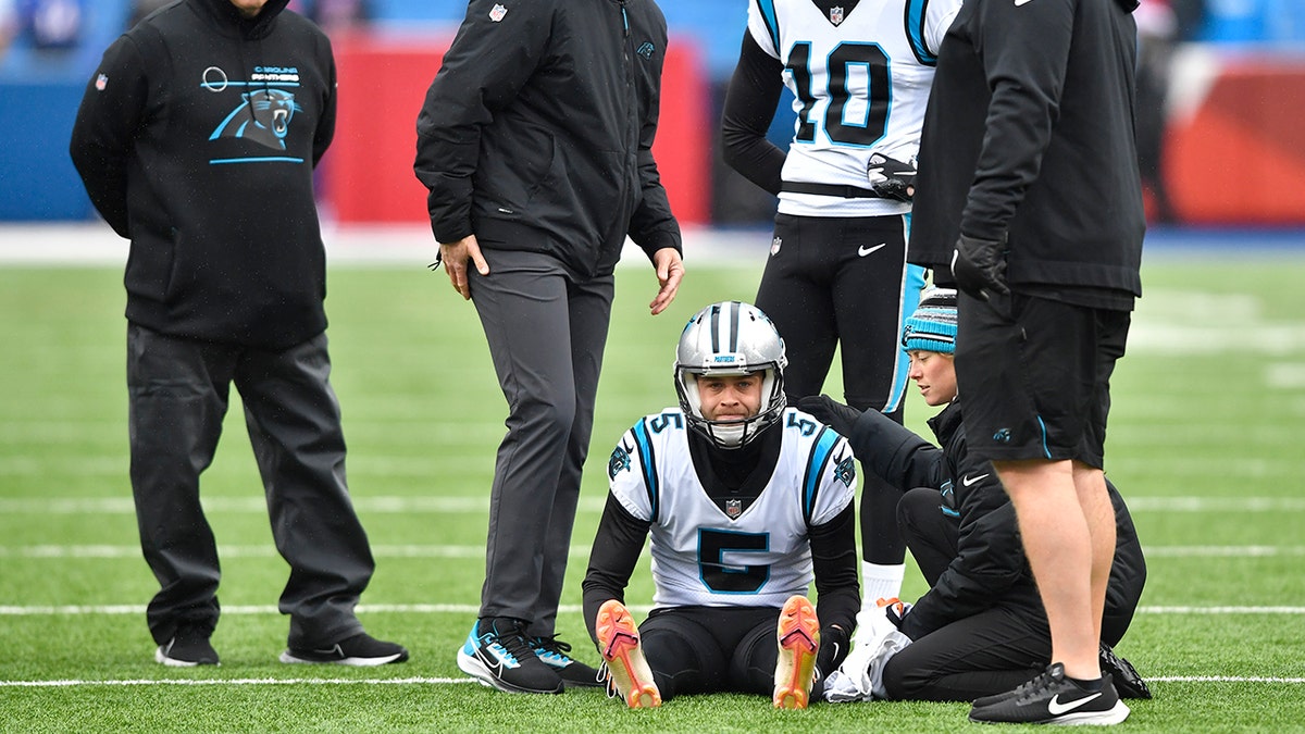 Carolina Panthers kicker Zane Gonzalez is checked after an apparent injury during practice before the Buffalo Bills game, Sunday, Dec. 19, 2021, in Orchard Park, New York.