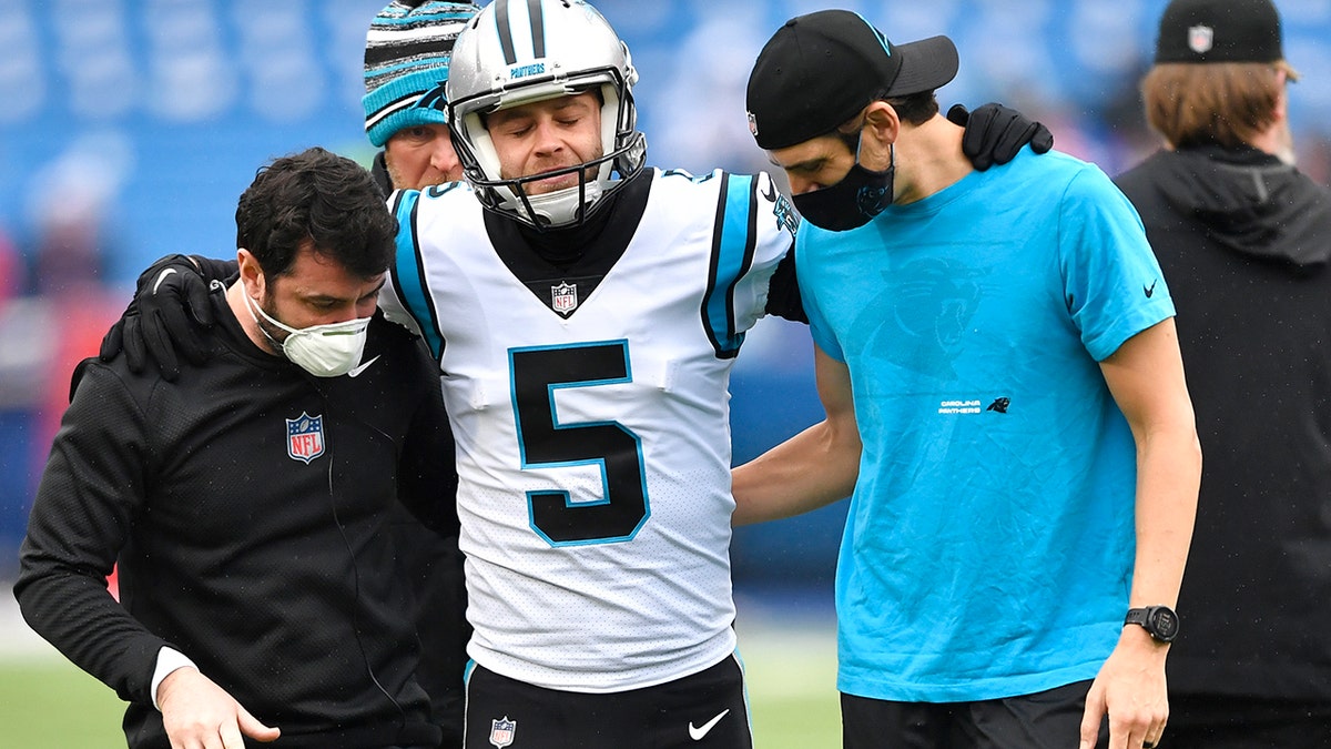 Carolina Panthers kicker Zane Gonzalez is helped off the field after an apparent injury during practice before the Buffalo Bills game, Sunday, Dec. 19, 2021, in Orchard Park, New York.