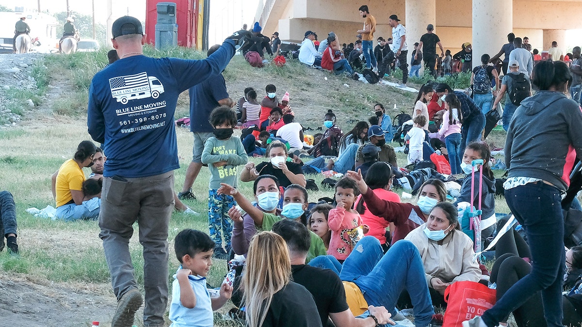 Migrants are seen at the Rio Grande near the Del Rio-Acuna Port of Entry in Del Rio, Texas, on Sept. 18, 2021.