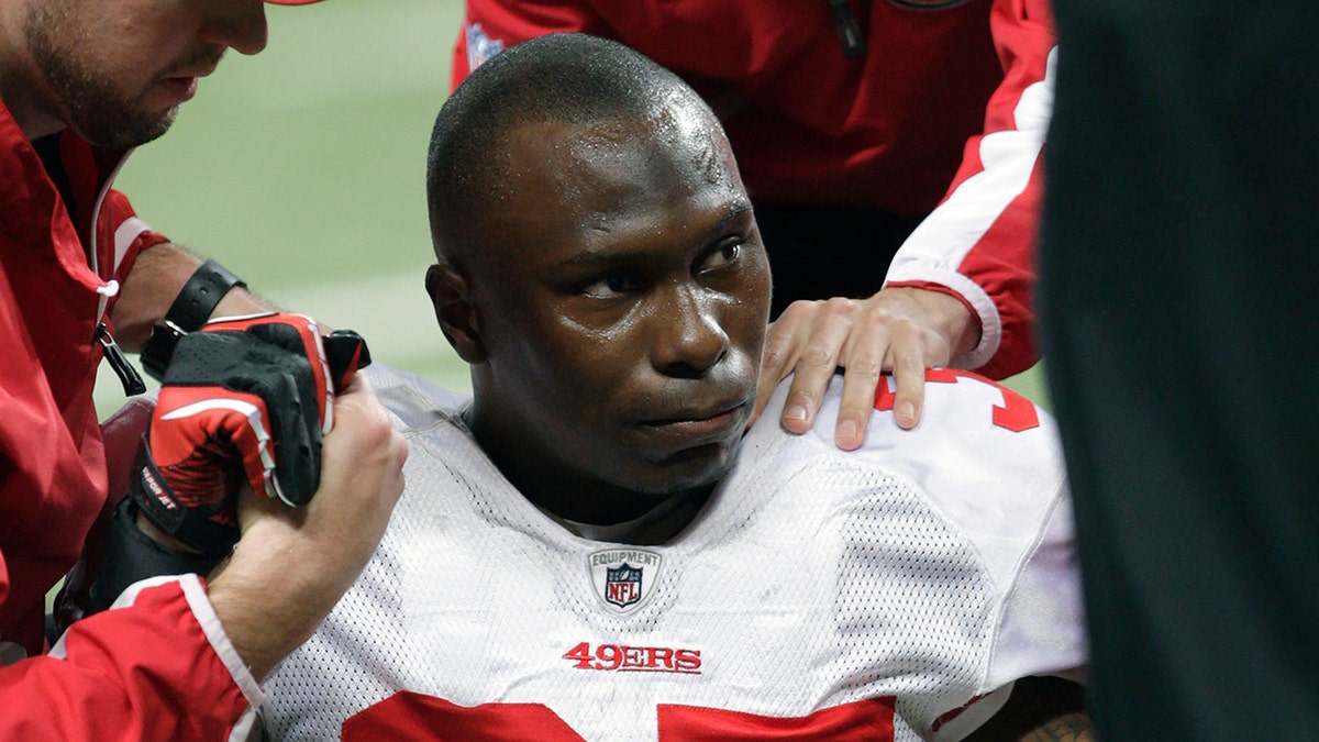 San Francisco 49ers cornerback Phillip Adams (35) is attended to after injuring his left leg during the third quarter of an NFL football game against the St. Louis Rams in St. Louis, Missouri.
