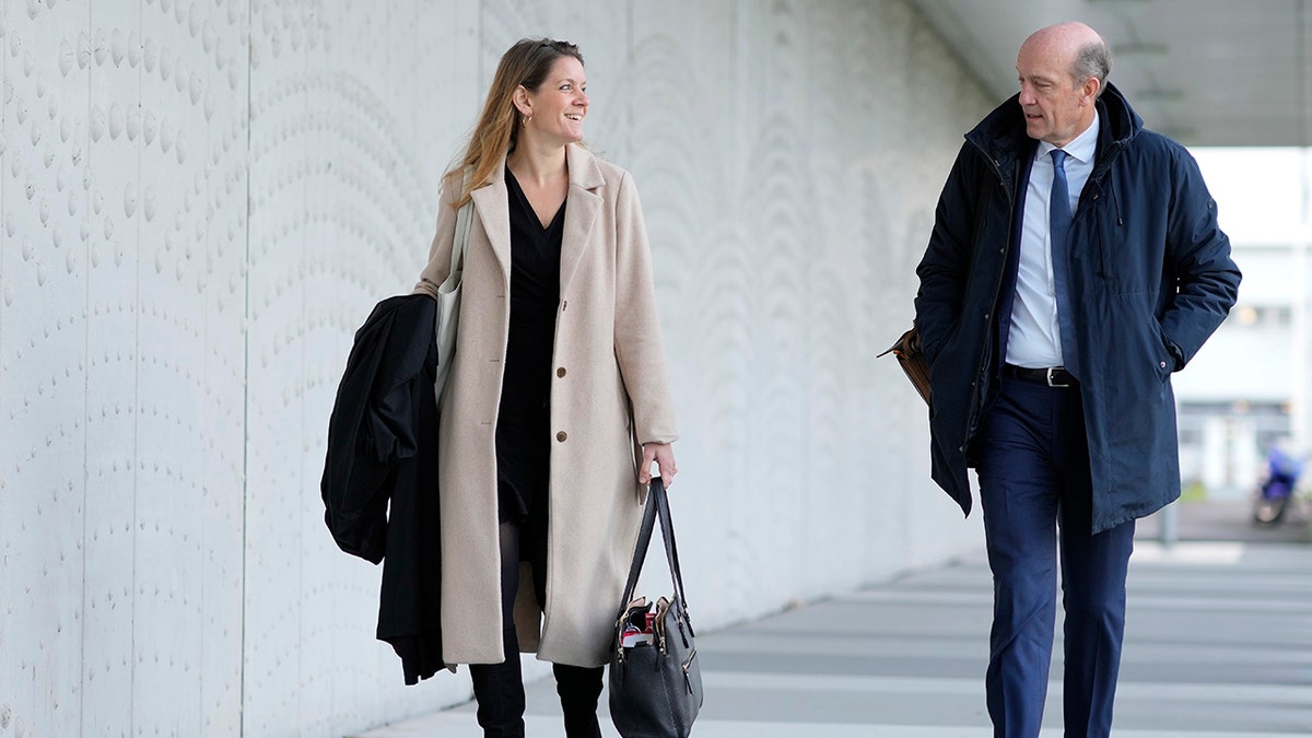 Lawyers for relatives Sabine ten Doesschate, left, and Boudewijn van Eijck arrive outside the court for the ongoing trial and criminal proceedings regarding the downing of Malaysia Airlines flight MH17, at the high security court at Schiphol airport, near Amsterdam, Netherlands, Monday Dec. 20, 2021.