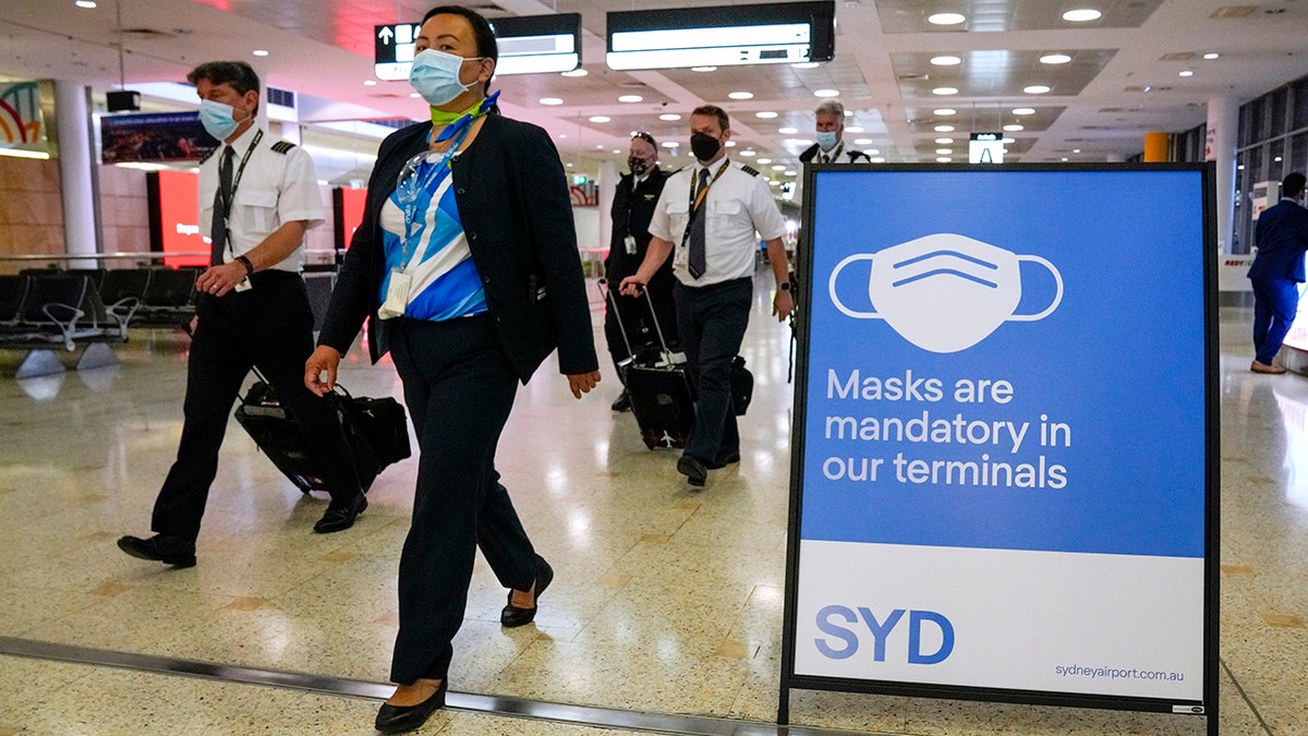 A flight crew walks through the terminal at Sydney Airport on Nov. 29, 2021.