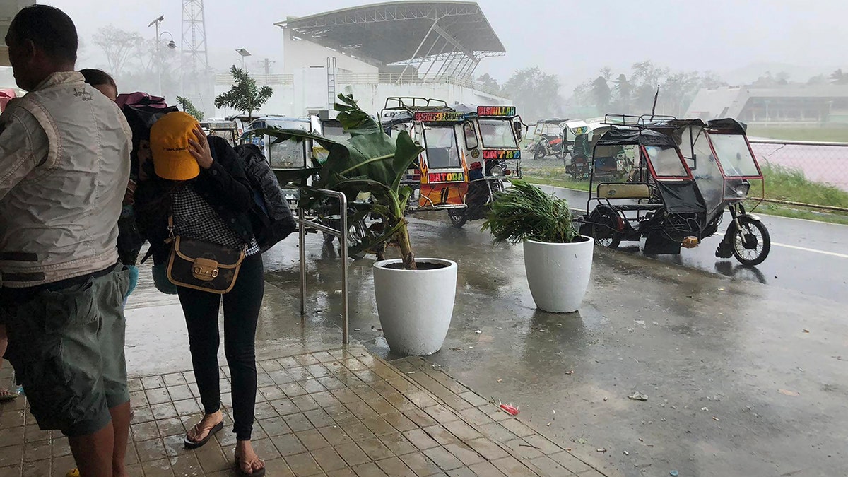 Storm evacuees take cover as strong winds blow in Dapa town, Siargao, Surigao del Norte province, southern Philippines on Thursday, Dec. 16, 2021. 
