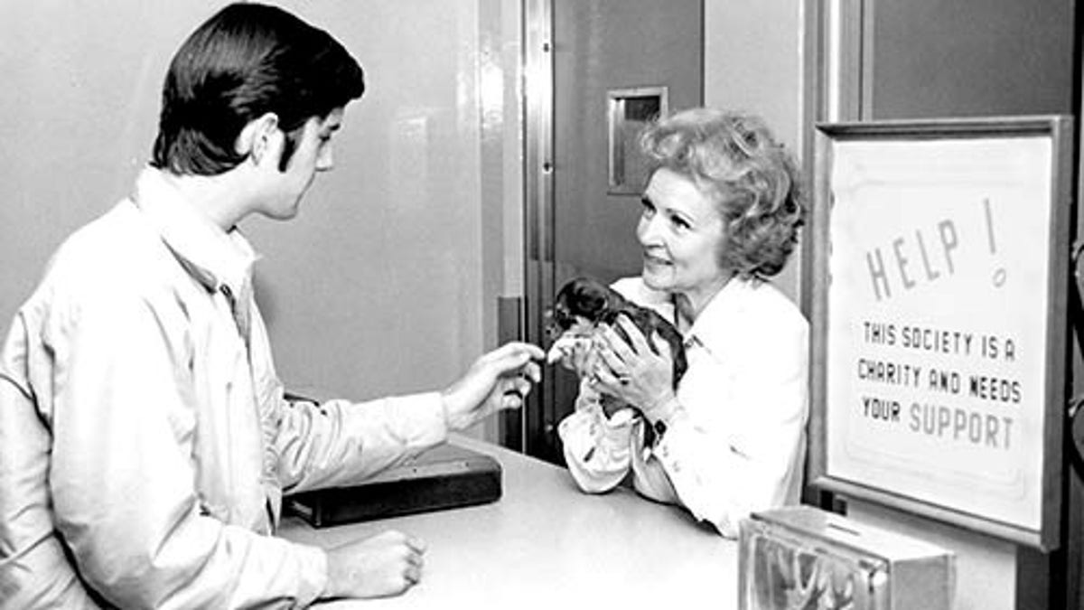 Betty White holding a puppy at an adoption center run by the Society for the Prevention of Cruelty to Animals Los Angeles. 