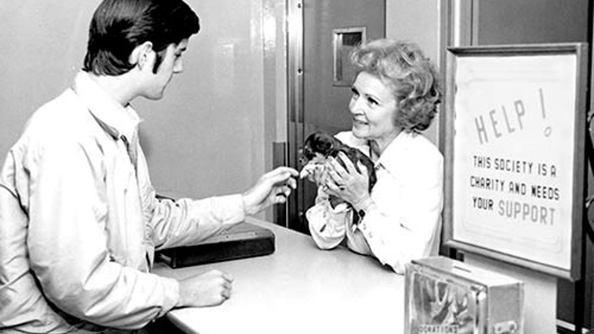 Betty White holding a puppy at an adoption center run by the Society for the Prevention of Cruelty to Animals Los Angeles.