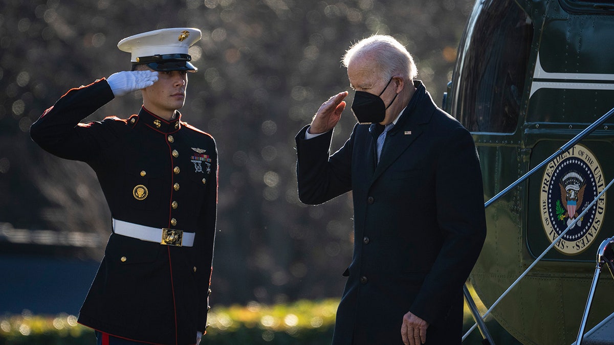 President Joe Biden salutes as he exits Marine One on the South Lawn of the White House