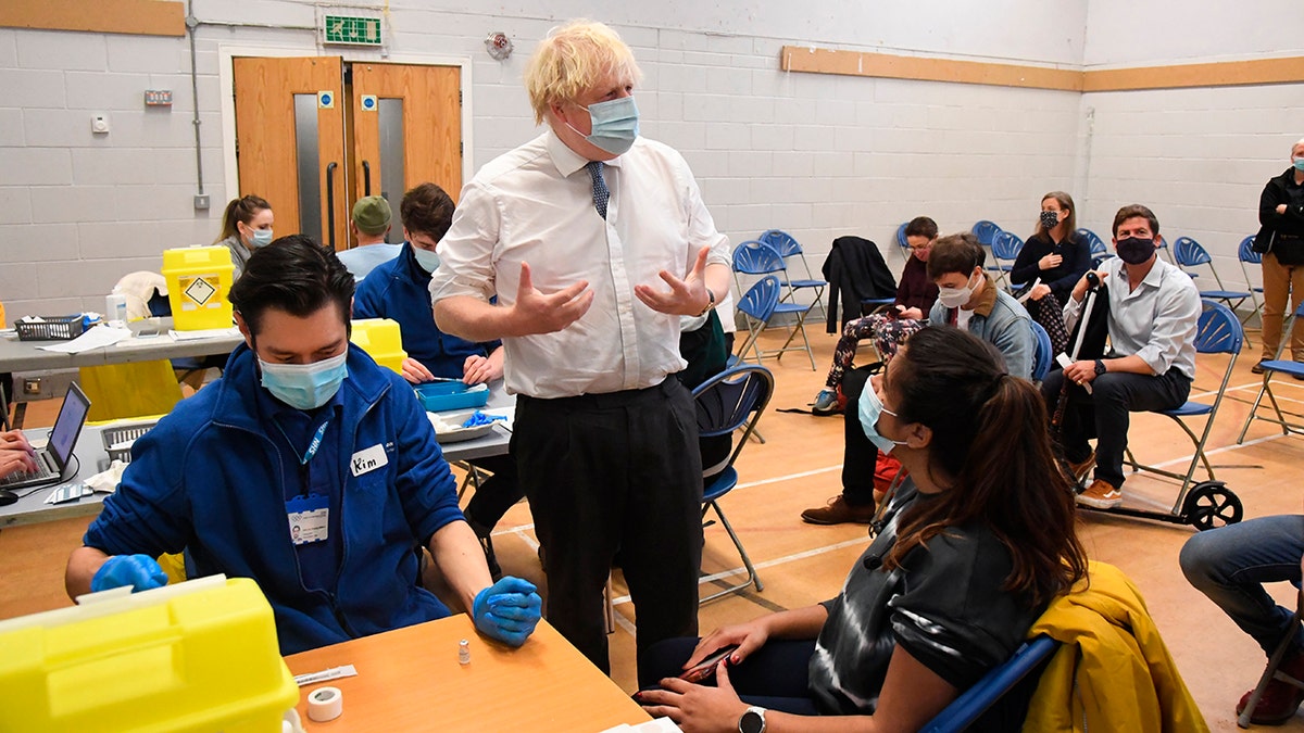 British Prime Minister Boris Johnson visits Stow Health Vaccination center, in Westminster, London, Monday, Dec. 13, 2021. 