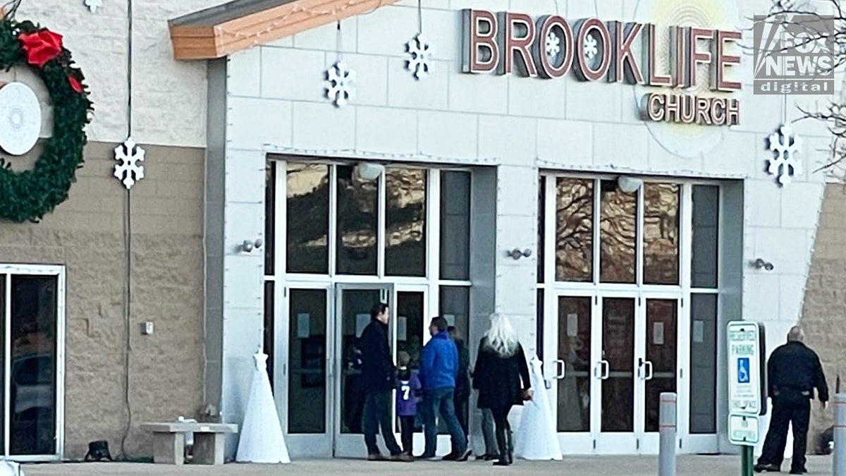 Mourners enter Brooklife Church in Mukwonago, Wisconsin, for a memorial service for Christmas parade victim Jackson Sparks, Dec. 2, 2021.