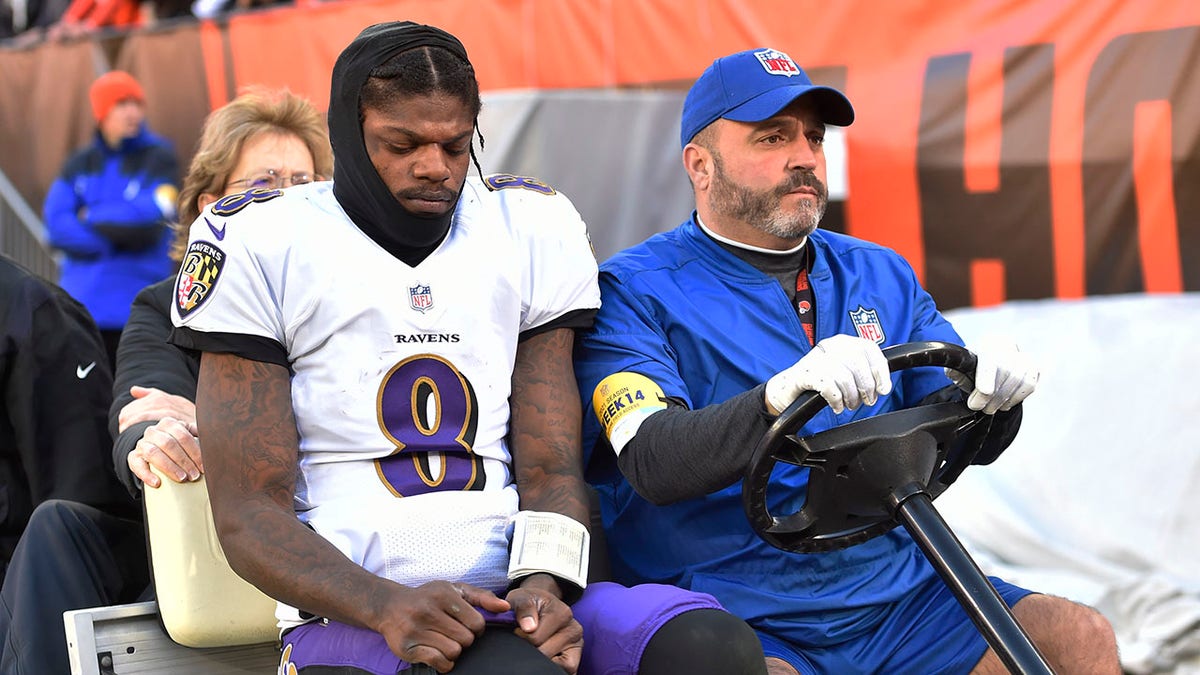 Baltimore Ravens quarterback Lamar Jackson (8) is carted off the field after an injury during the first half of an NFL football game against the Cleveland Browns, Sunday, Dec. 12, 2021, in Cleveland.