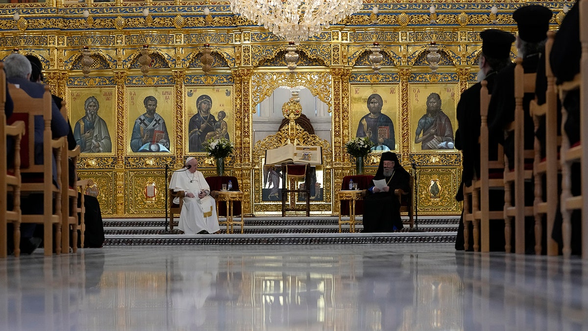 Pope Francis, left, listens to Archbishop Chrisostomos during a ceremony at the Apostolos Barnavas Orthodox Cathedral in Nicosia, Cyprus, Friday, Dec. 3, 2021. 