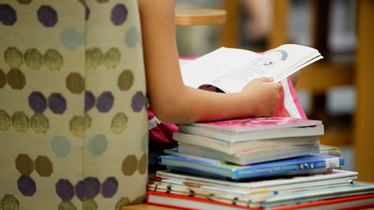 A child reads a book at the City of Santa Clarita Public Library Valencia branch in Santa Clarita, California, on Nov. 1, 2015. 