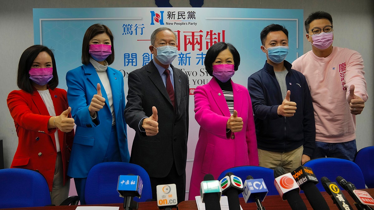 Members of New People's Party, from left, Judy Chan, Eunice Yung, Lai Tung-kwok, Regina Ip, Dominic Lee and Marcus Liu pose for a photograph during a press conference after winning the legislative election in Hong Kong, Monday, Dec. 20, 2021.