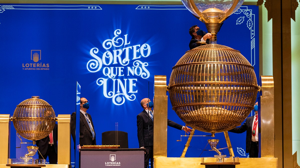 Workers prepare numbered lottery balls at Madrid's Teatro Real opera house during Spain's bumper Christmas lottery draw known as El Gordo, or The Fat One, in Madrid, Spain, Wednesday, Dec. 22, 2021.