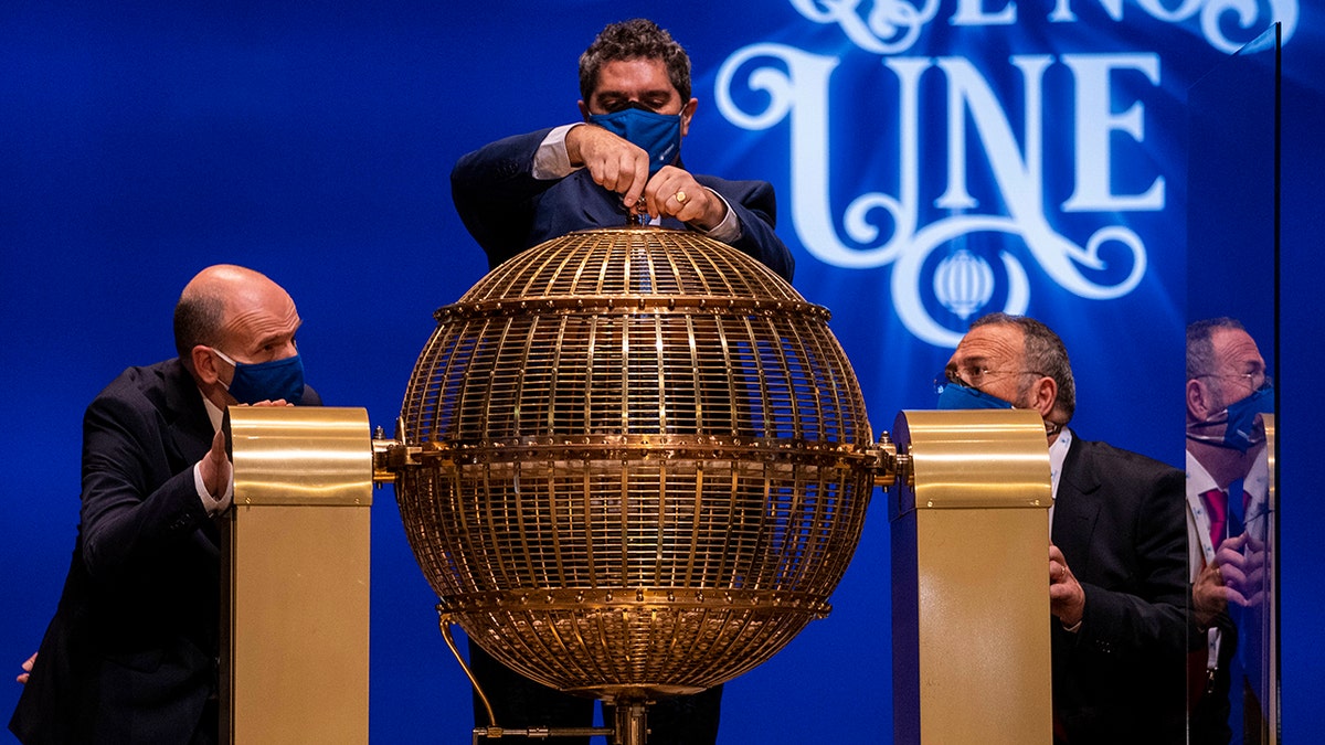 Workers prepare prize lottery balls at Madrid's Teatro Real opera house during Spain's bumper Christmas lottery draw known as El Gordo, or The Fat One, in Madrid, Spain, Wednesday, Dec. 22, 2021.