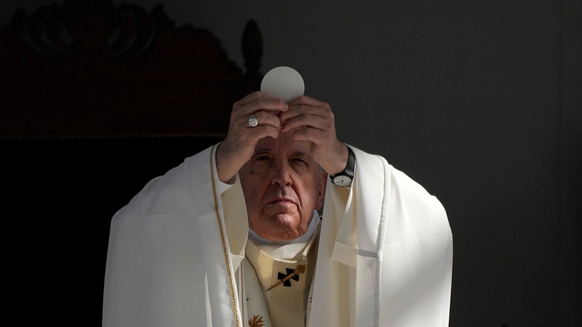 Pope Francis consecrating the Eucharist