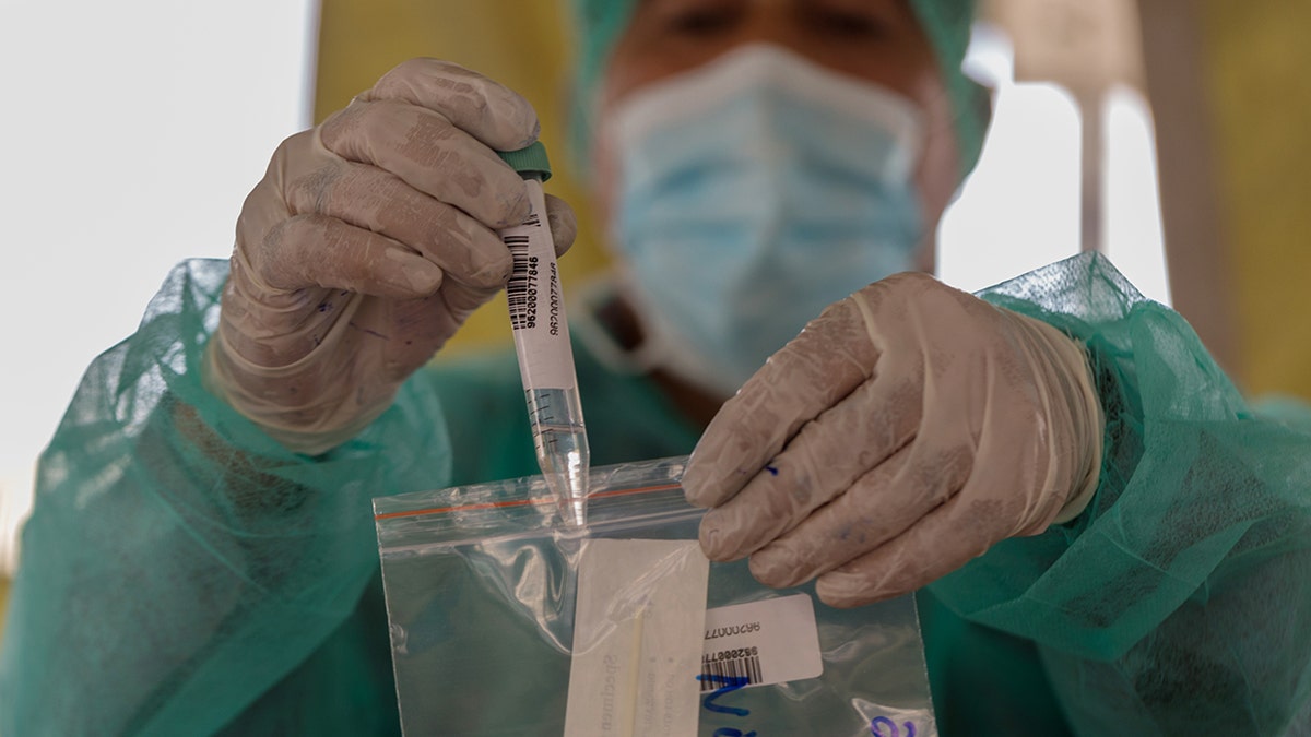 A health worker bags a swab at a COVID-19 testing facility in Karachi, Pakistan, on Jan. 28, 2021.