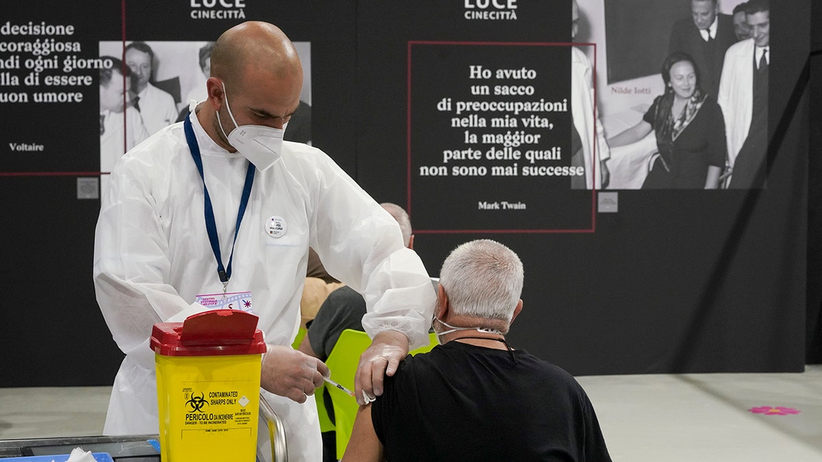 A man receives a dose of the Pfizer COVID-19 vaccine, at a vaccination center set at Rome's Cinecitta' film studios, on April 20, 2021.