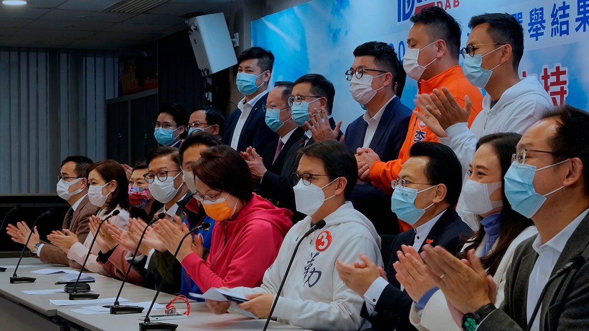 Members of pro-Beijing party Democratic Alliance for Betterment of Hong Kong (DAB), including Starry Lee Wai-king, fifth from right, clap during a press conference after winning 19 seats in the Legislative election in Hong Kong, Monday, Dec. 20, 2021.