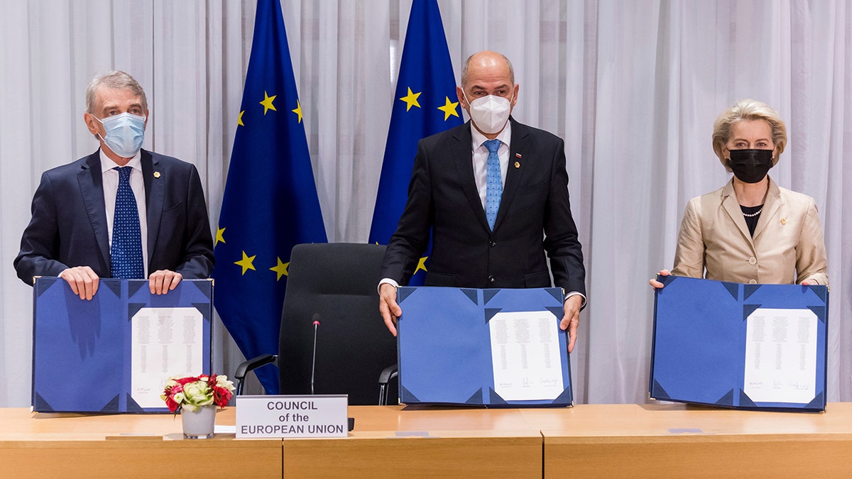 From left, European Parliament President David Sassoli, Slovenia's Prime Minister Janez Jansa and European Commission President Ursula von der Leyen during a signing ceremony of EU Legislative Priorities for 2022 on the sidelines of an EU Summit in Brussels, Thursday, Dec. 16, 2021. 