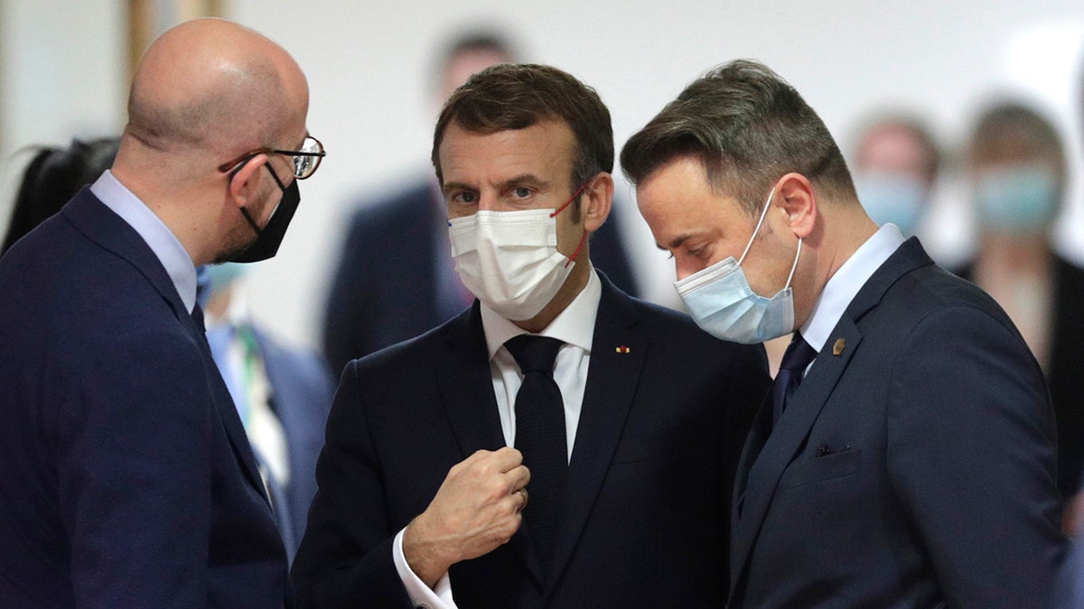 French President Emmanuel Macron, center, speaks with European Council President Charles Michel, left, and Luxembourg's Prime Minister Xavier Bettel, right, during a round table meeting at an EU Summit in Brussels, Thursday, Dec. 16, 2021. 