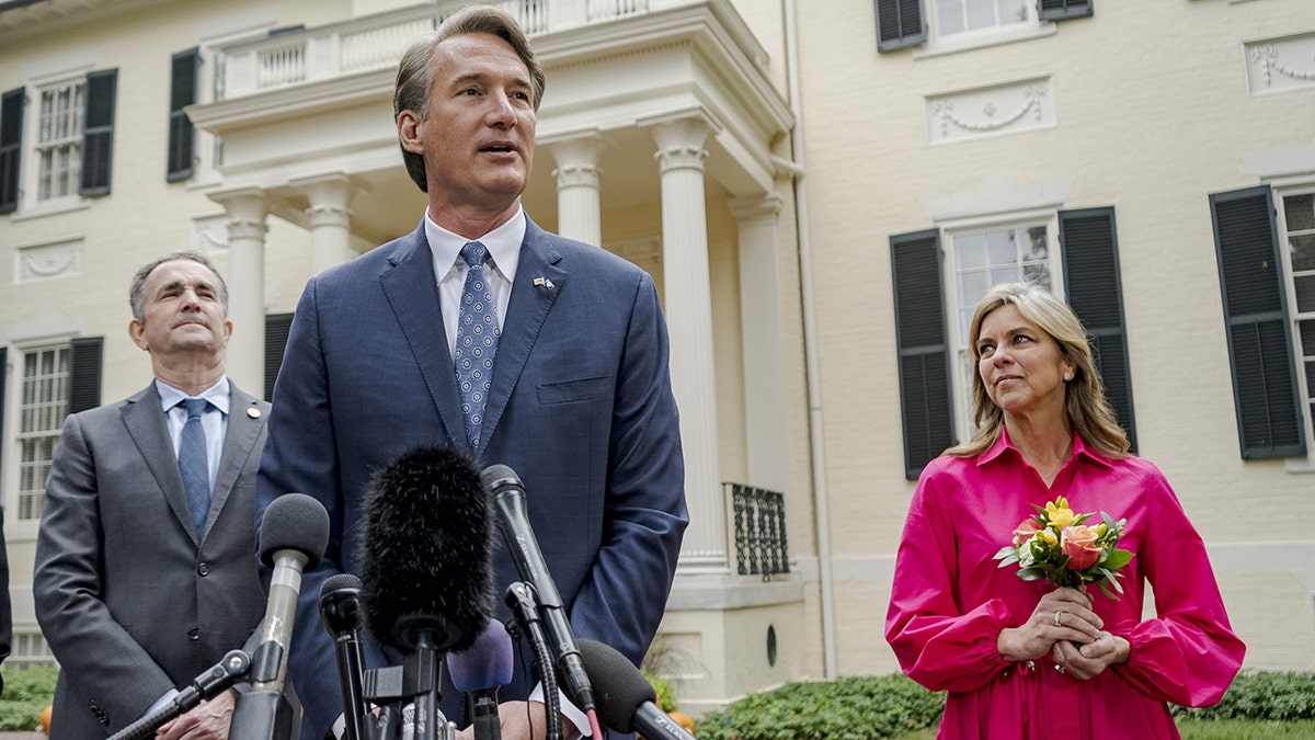 Glenn Youngkin, governor-elect of Virginia, center, speaks to members of the media as Ralph Northam, governor of Virginia, left, and Suzanne Youngkin listen outside the Executive Mansion in Richmond, Virginia, on Thursday, Nov. 4, 2021.
