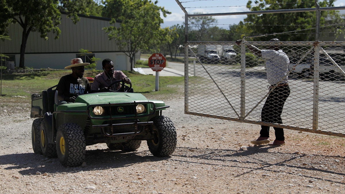 Workers ride out of the gate of the Christian Aid Ministries headquarters in Titanyen, north of Port-au-Prince, Haiti, Monday, Dec. 6, 2021.?