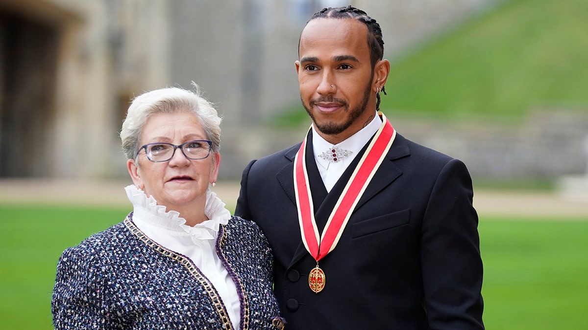 Lewis Hamilton was accompanied to the ceremony at Windsor Castle by his mother Carmen Lockhart.