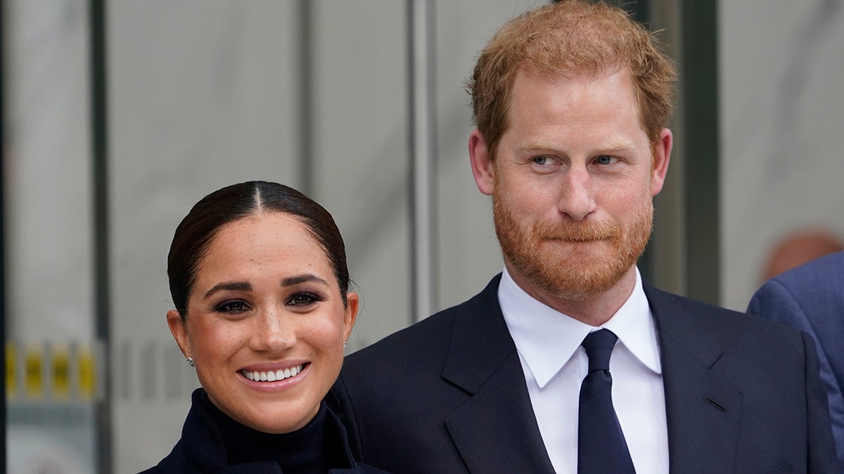 Meghan Markle and Prince Harry pose for pictures after visiting the observatory in One World Trade in New York, Thursday, Sept. 23, 2021. 