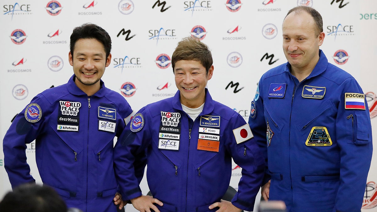 Alexander Misurkin, right, Yusaku Maezawa, center, and Yozo Hirano attend a news conference in Moscow on Oct. 14, 2021. 