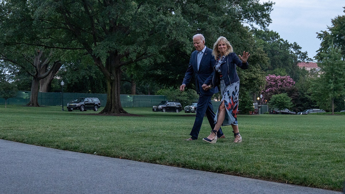 The Bidens walk on the South Lawn of the White House after arriving on Marine One in Washington, July 19, 2021.