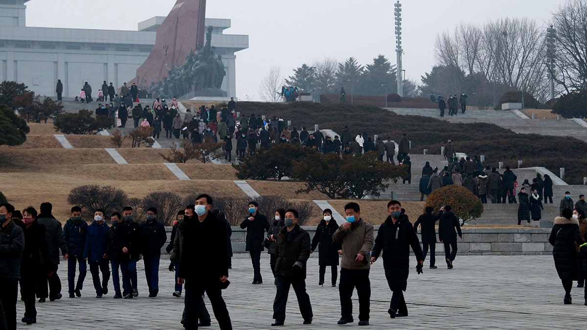 Citizens visit the bronze statues of their late leaders Kim Il Sung and Kim Jong Il on Mansu Hill in Pyongyang, North Korea Thursday, Dec. 16, 2021, on the occasion of 10th anniversary of demise of Kim Jong Il. 