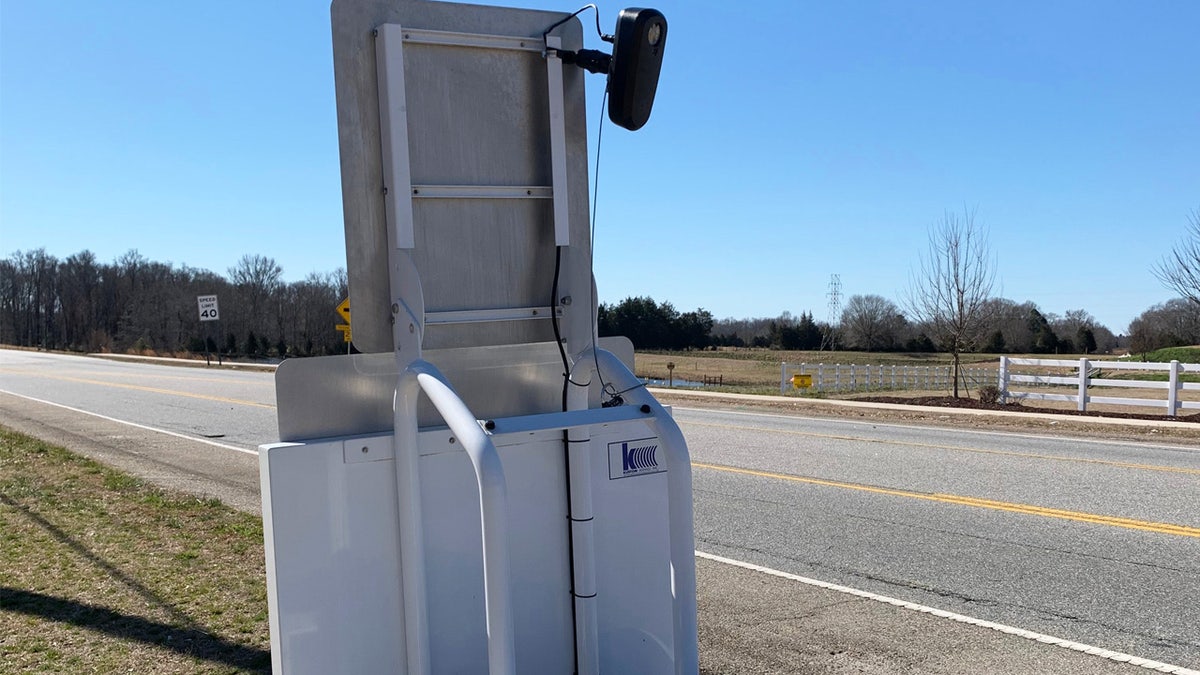 A license plate reader scanning passing cars. 