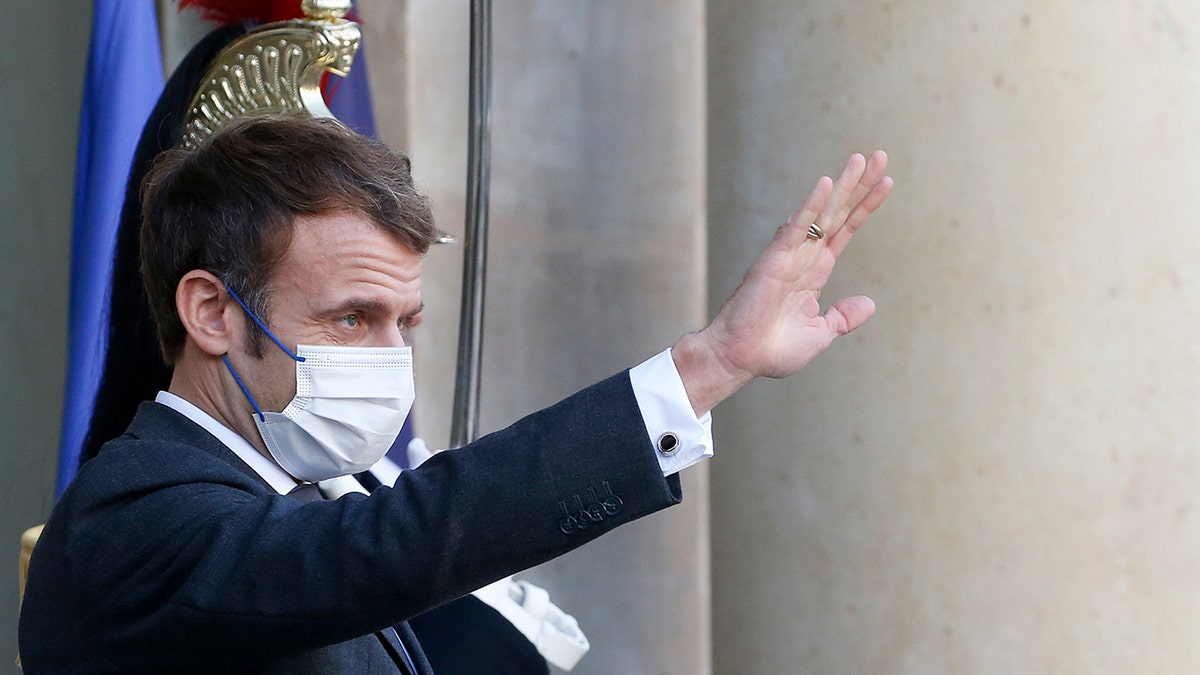 French President Emmanuel Macron wearing a protective face mask waves in Paris, France. (Getty Images)