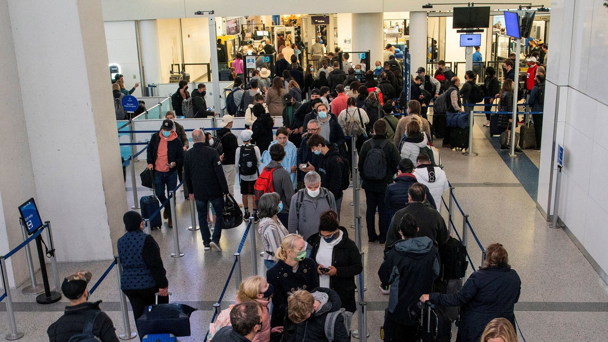 FILE PHOTO: Passengers wait in line inside the terminal at Newark Liberty International Airport in Newark, New Jersey, U.S., November 24, 2021. REUTERS/Eduardo Munoz