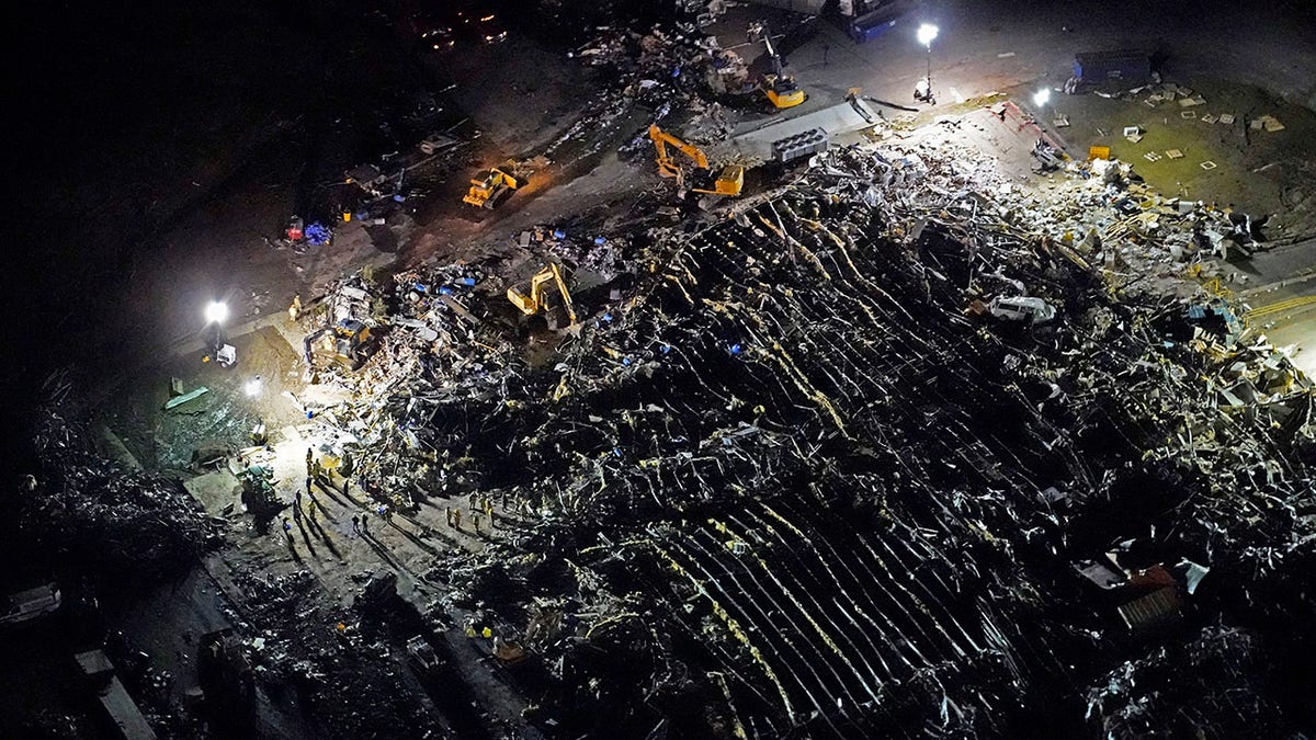 In this aerial photo, a collapsed factory is seen with workers searching for survivors, after tornadoes came through the area the previous night, in Mayfield, Ky., Saturday, Dec. 11, 2021. (AP Photo/Gerald Herbert)