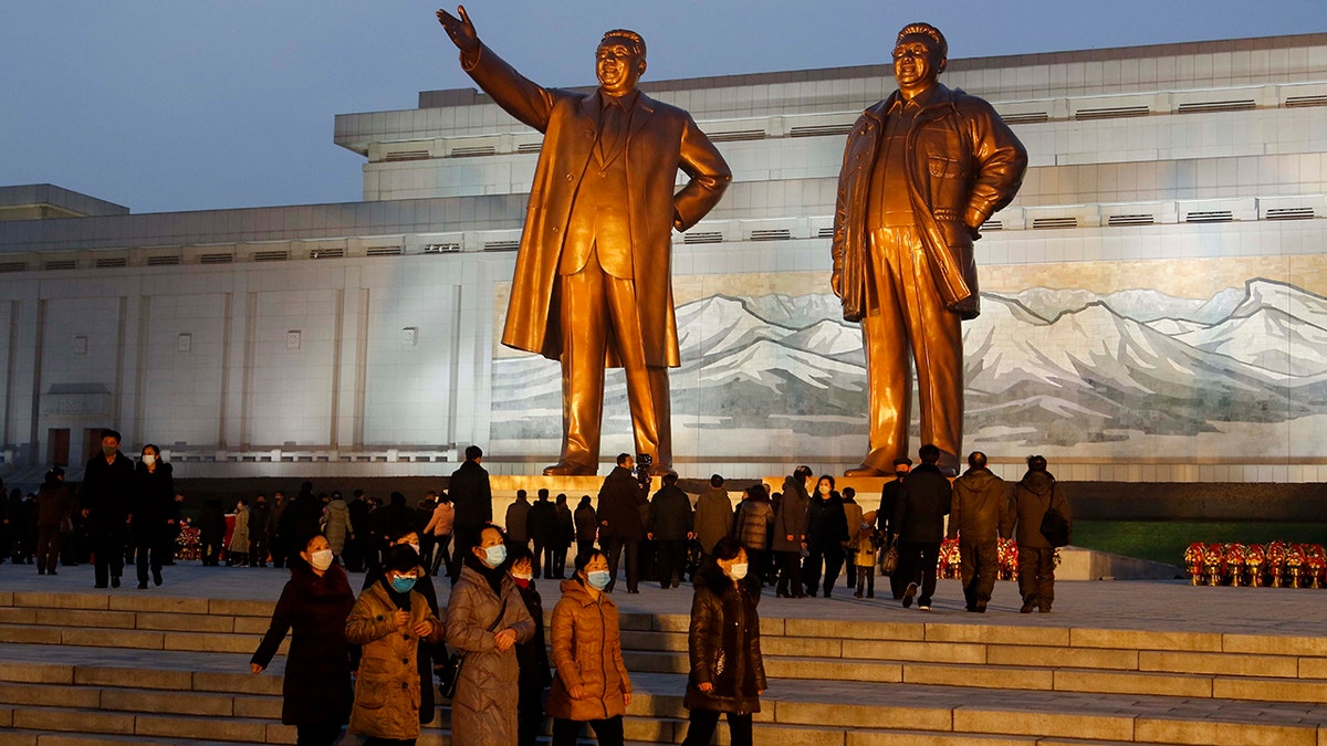 Citizens visit the bronze statues of their late leaders Kim Il Sung, left, and Kim Jong Il on Mansu Hill in Pyongyang, North Korea Thursday, Dec. 16, 2021, on the occasion of 10th anniversary of demise of Kim Jong Il.
