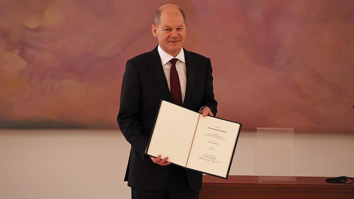 BERLIN, GERMANY - DECEMBER 08: New German Chancellor Olaf Scholz holds his certificate of appointment at Bellevue palace on December 8, 2021 in Berlin, Germany. (Photo by Emmanuele Contini/Getty Images)