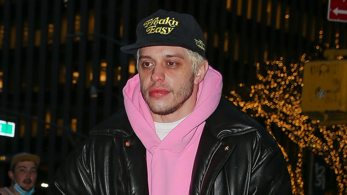 Pete Davidson walks in New York wearing a pink hoodie