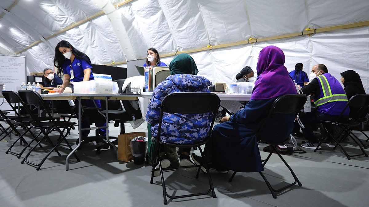 Afghan refugee women register to be seen by a doctor inside the medical tent at Liberty Village on Joint Base McGuire-Dix- Lakehurst, New Jersey, on Dec, 2, 2021.