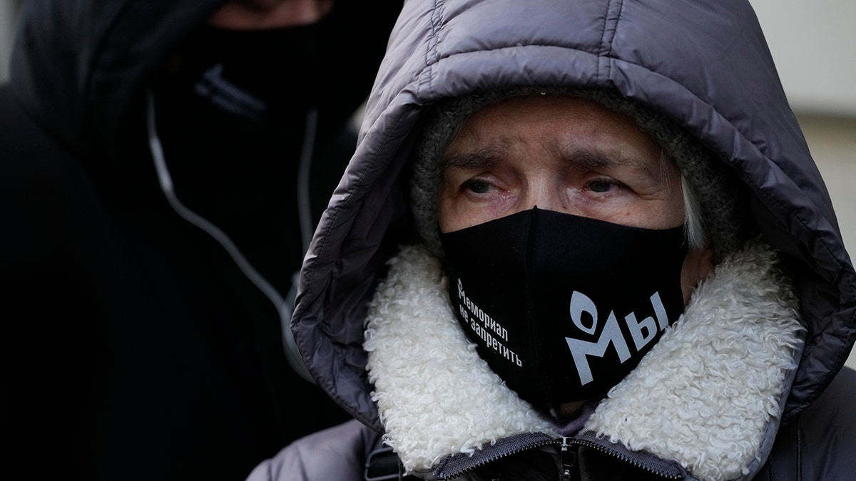 Supporters of the Memorial human rights group wearing face masks with the words "The Memorial cannot be banned!" gather in front of the Supreme Court of the Russian Federation in Moscow, Russia, Tuesday, Dec. 28, 2021.